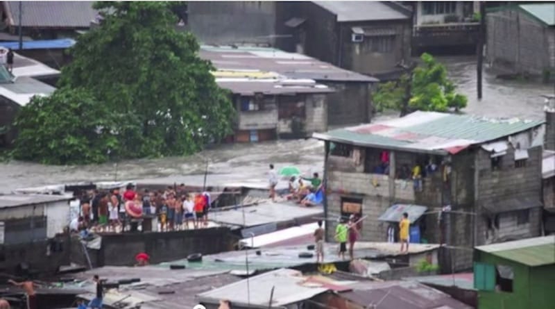 People sought safety on rooftops during the floods in the Philippines. Photo: joeycm / Youtube