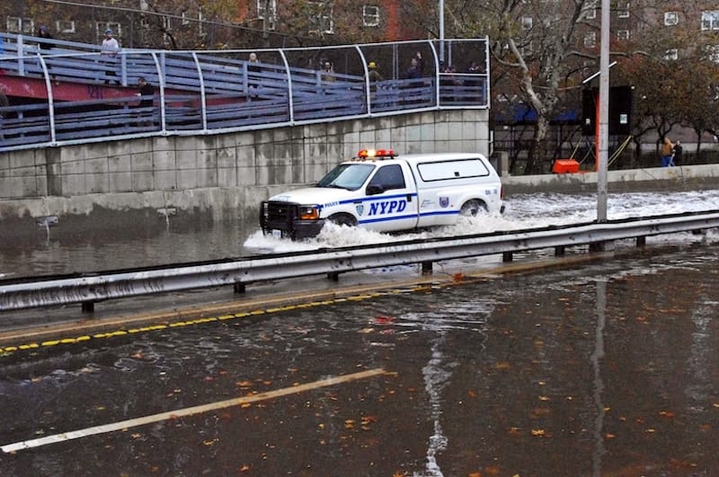Police make their way through flooded streets near the East Village in Manhattan. Photo: David Shankbone/Wikimedia Commons