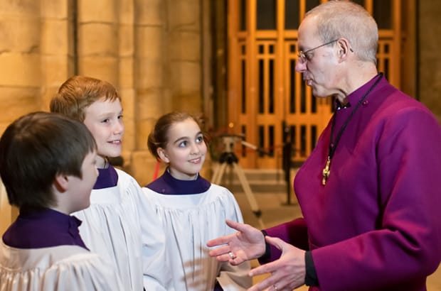 Justin Welby, bishop of Durham, chats with choristers as he prepares to leave the diocese to take up his new position as Archbishop of Canterbury. Photo: Keith Blundy