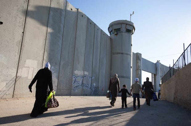Palestinian women and children pass through the Bethlehem checkpoint in August 2012. Photo: Ryan Rodrick Beiler/Shutterstock