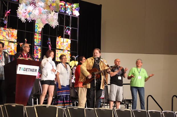 Bishop Mark MacDonald leads the singing with the ACIP members during their presentation. Photo: Art Babych