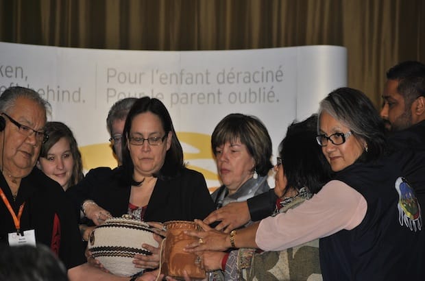 Members of the B.C. Indian Residential Schools Survivors' Society receive sacred fire ashes from the Quebec National Event held in Montreal last April. Photo: Marites N. Sison