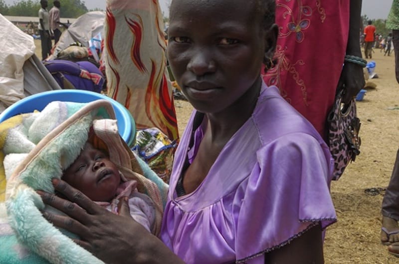 Yom Ayuen and her three-year-old baby arrived with other members of her family are among the refugees who have fled the conflict in South Sudan. Photo: ACT/DCA/LWF/Mai Gad