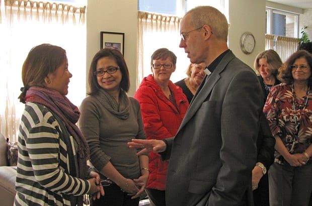 (Left to right) Cynthia Herrera and Emily Fe Honoridez chat with Archbishop of Canterbury Justin Welby as their co-workers Margaret Davidson, Evelyn Hinchcliffe, Kathy Edgar and Teresa Mandricks wait to welcome him to the national offices of the Anglican Church of Canada in Toronto. Photo: Leigh Anne Williams