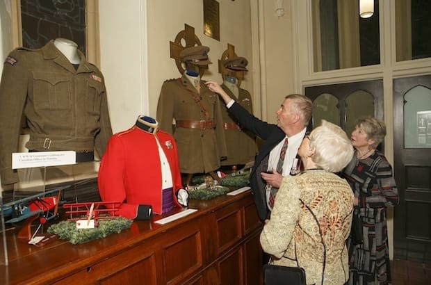 Visitors to the opening of Called to Serve admire some of the many vintage uniforms on display. Photo: Michael Hudson