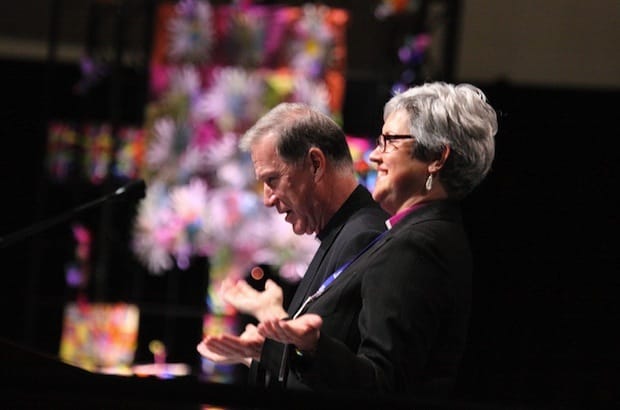 Archbishop Fred Hiltz and Bishop Susan Johnson lead Anglican and Lutheran members of the 2013 Joint Assembly in prayer at the Ottawa Convention Centre. Photo: Art Babych