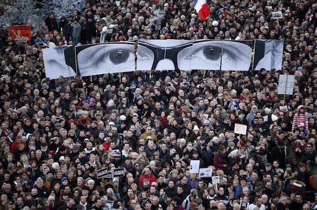 Marchers hold panels depicting the eyes of Charlie Hebdo editor Stephane Charbonnier, who was among the 17 killed by gunmen who opened fire at the satirical newspaper’s headquarters in Paris on Jan. 7. Photo: Charles Platiau/Reuters