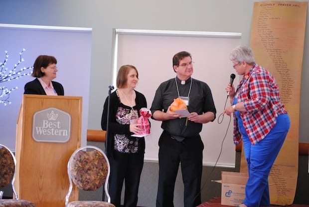 The Rev. Isabel Healy-Morrow (L) and Bishop Barbara Andrews (R) of the Anglican Parishes of the Central Interior (APCI) present Montreal partners Lynn O’Donnell and the Rev. Andy O’Donnell with gifts at the APCI assembly. Photo: André Forget