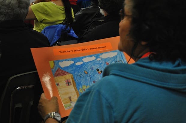 A former residential school student holds an artwork given by a local grade school student at the Truth and Reconciliation National Event held in Inuvik in 2011. Photo: Marites N. Sison