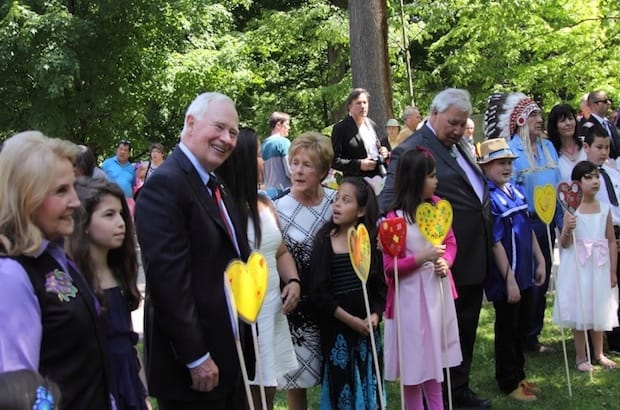 TRC Commissioner Marie Wilson, Governor General David Johnston, vice-regal consort Sharon Johnston, TRC chair Justice Murray Sinclair, Commissioner Chief Wilton Littlechild and a number of their grandchildren plant paper hearts on Rideau Hall grounds. Photo: Art Babych