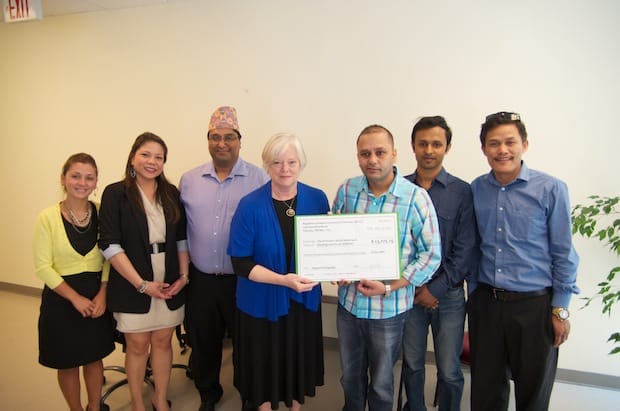 Board members of the Nepalese Canadian Community Services present PWRDF with a cheque for $13,075.25 for earthquake relief at PWRDF offices in Toronto. Photo: Simon Chambers