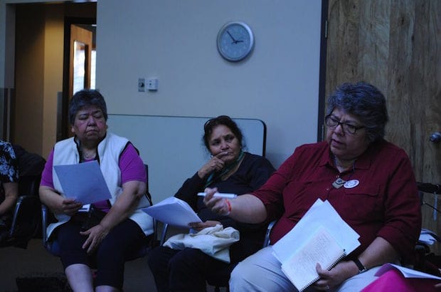 Audrey Barton and Barbara Bighead listen as Canon Ginny Doctor explains how healthy ways forward require Indigenous people to confront their history. Photo: André Forget