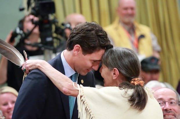 Prime Minister Justin Trudeau, sworn in as Canada's prime minister Nov. 4, has promised a "renewed nation-to-nation relationship with Indigenous peoples that respects rights and honours treaties." He is seen here embracing Evelyn Commanda Dewache, an Algonquin elder and former residential school student during the closing ceremony of the Truth and Reconciliation Commission in Ottawa June 3. Photo: Art Babych