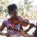 Justice Camp participants Náyade Bailly (left) and Mike Lickers (right) practice a song together at the Roman Catholic Retreat Centre in Matanzas. Photo: Annalee Giesbrecht