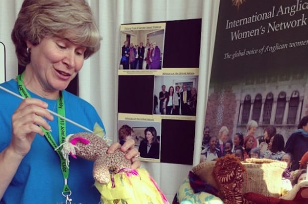 A representative from the Inter-Anglican Women’s Network (IAWN) booth at Joint Assembly 2013 explains the rag doll project, which highlights the issue of human trafficking. The IAWN will have a booth at General Synod 2016. Photo: Marites Sison
