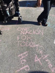 Following the Nov.13 Spanish-language mass at Church of Our Saviour, attendees used chalk to write messages of love, peace and welcome on sidewalks and the street outside the church. Here the message written in pink chalk reads "One Nación For Todos" or "One Nation For All" in Spanish and English. Photo: Facebook