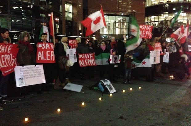 As the battle for Aleppo intensifies, Toronto activists stage a rally Dec. 14 calling for the protection of civilians. The UN human rights office says it has received reports of civilians being killed, “either by intense bombardment or summary execution by pro-government forces.” Photo: M. Sison