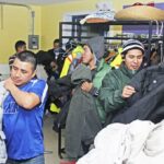 Migrant farmworkers in Fenwick, Ont., try on winter coats at a free store run by St. Alban’s Anglican Church, Beamsville, funded, in part, by a grant from the Anglican Foundation of Canada. Photo: Contributed