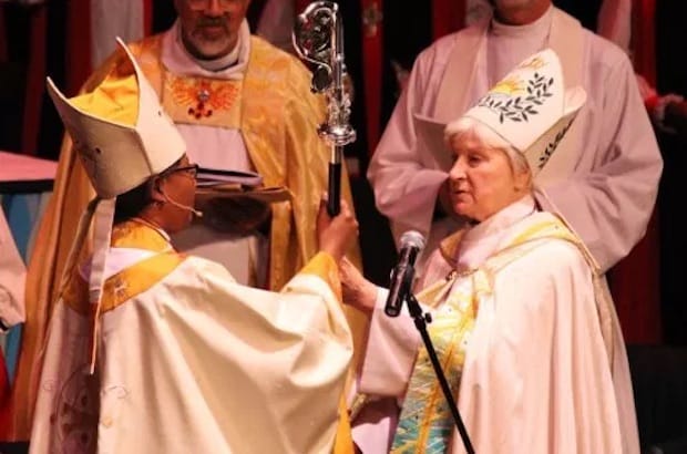 Bishop Catherine Waynick hands the crozier to Bishop Jennifer Baskerville-Burrows. Saturday's consecration was the first time in Episcopal Church history that a female bishop has transferred authority to another female bishop. Photo: Meghan McConnell
