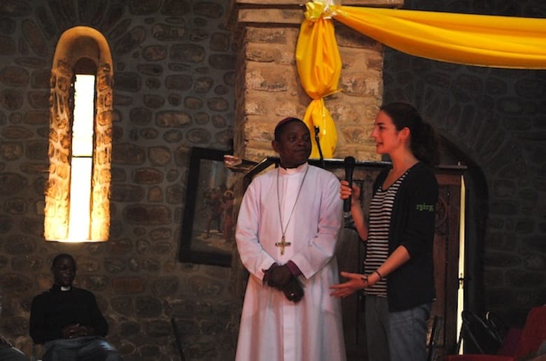 Board member and youth delegate Asha Kerr-Wilson introduces herself at St. Mary and St. Bartholomew Cathedral in Masasi, while Bishop James Almasi translates. Photo: André Forget