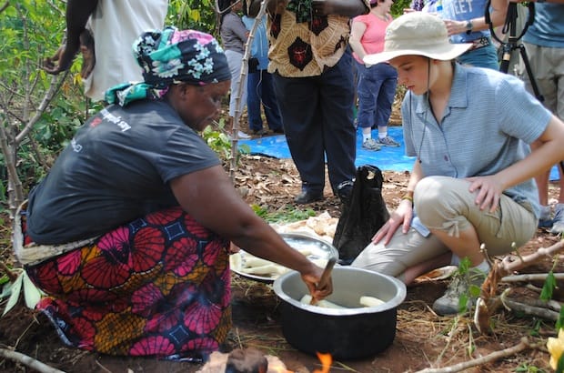 Joyce Mtauka shows PWRDF youth delegate Leah Marshall how to cook recently harvested cassava. Photo: André Forget