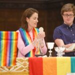 Lyds Keesmaat-Walsh (right) prepares the Eucharist with the Rev. Molly Finlay during the Pride service at Church on Tap, a monthly event at Christ Church Deer Park in Toronto. Photo: Michael Hudson