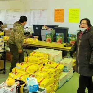 Volunteers sort supplies into household packages in the gym of Bearskin Lake’s Michikan Lake high school. Photo: Phyllis McKay