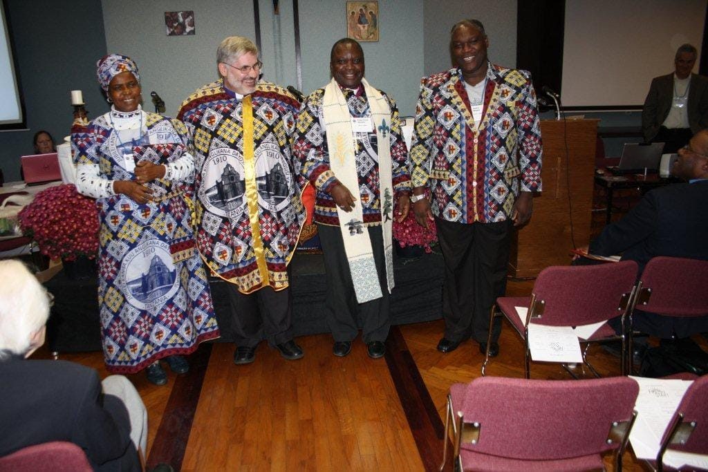 Bishop Barry Clarke of Montreal, with Masasi diocesan partners Bishop Patrick Mwachiko and Geofrey Monjesa. At left, Emericiana Mwachiko, wife of Bishop Patrick, is president of the diocesan Mothers' Union. Photo: Harvey Shepherd