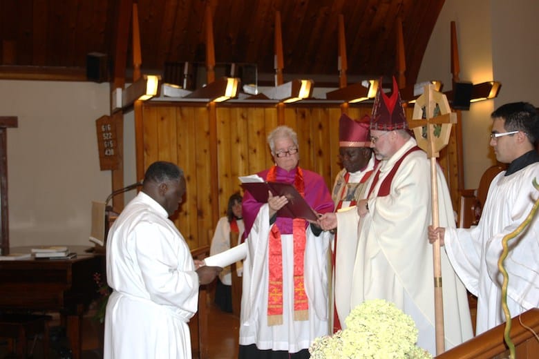 Geofrey Monjesa is ordained as a deacon by Bishop Barry Clarke aided by Bishop Patrick Mwachiko and executive archdeacon Janet Griffith. Photo: Harvey Shepherd