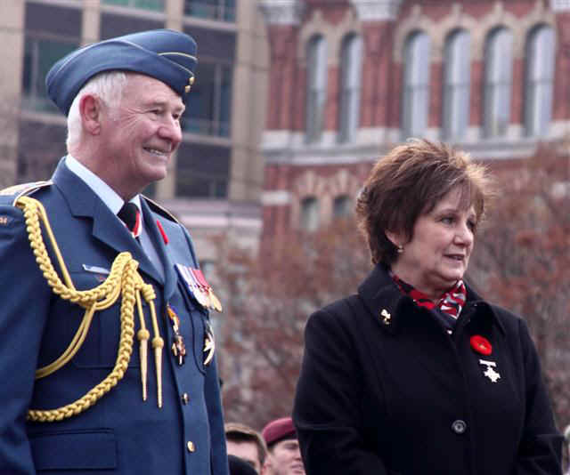 Wearing the blue uniform of the Royal Canadian Airforce, Governor General David Johnston is accompanied on the reviewing stand by Roxanne Priede, this year’s National Silver Cross Mother. Her son, Master Corporal Darrell Jason Priede, died in a helicopter crash in Afghanistan in 2007. Photo: Art Babych