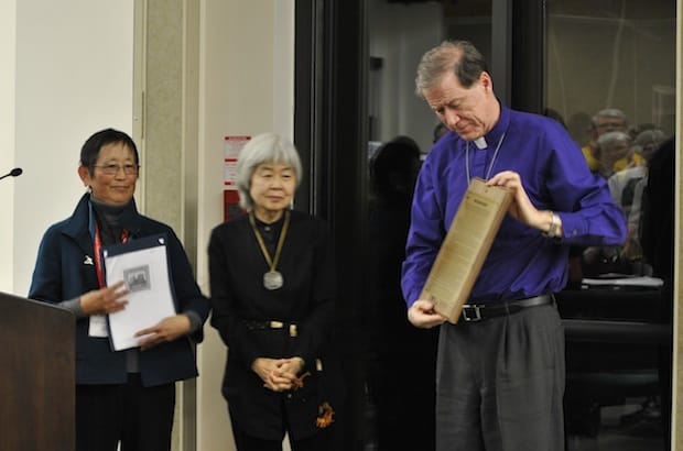 (L to R) Lynne Shozawa and Joy Kogawa present Archbishop Fred Hiltz with a memorial plaque that tells the story about the fate of Japanese Canadian Anglican churches before and after World War II. Photo: Marites N. Sison