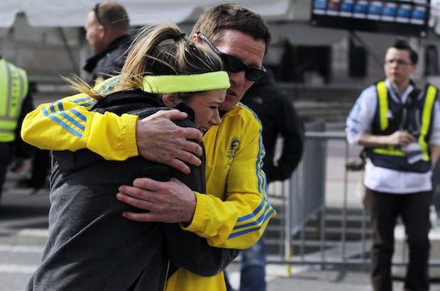 A woman is comforted by a man near a triage tent set up for the Boston Marathon after explosions went off at the 117th Boston Marathon in Boston, Massachusetts April 15, 2013. Photo: Jessica Rinaldi/REUTERS