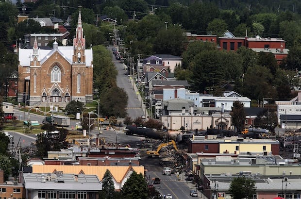 Workers begin digging at the site of a derailment in Lac Megantic, Quebec. A driverless, runaway fuel train that exploded in a deadly ball of flames in the center of this small town rumbled down an empty track minutes after a fire crew extinguished a blaze in one of its parked locomotives. Photo: REUTERS/Christinne Muschi
