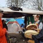 Victoria's tent city residents greet Bishop Logan McMenamie with drumming during his visit March 26. Photo: Super InTent City Facebook page