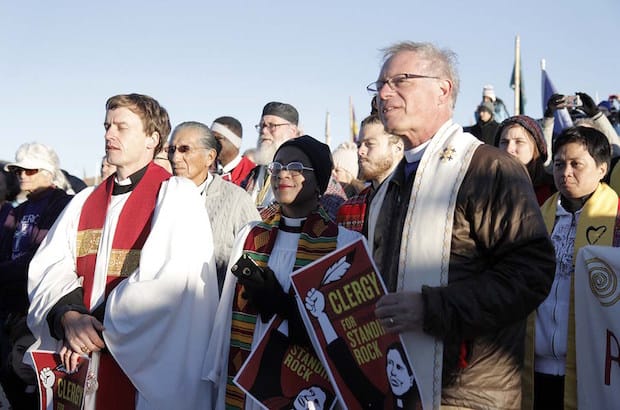 The Rev. Stephanie Spellers (middle), canon to the presiding bishop for evangelism and reconciliation, and California Bishop March Andrus, right, join more than 500 interfaith clergy and laity in showing solidarity to opponents of the Dakota Access Pipeline. Photo: Lynette Wilson/Episcopal News Service