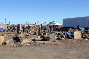 Firewood from this pile keeps the sacred fire burning around the clock in the center of the Oceti Sakowin Camp. Photo: Lynette Wilson/Episcopal News Service