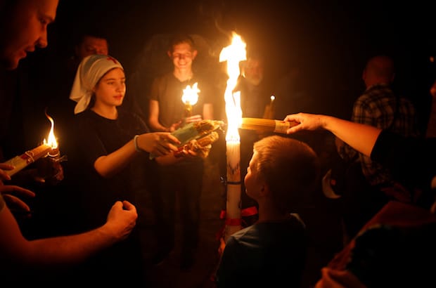 Pilgrims take part in the Christian Orthodox Holy Fire ceremony at the Church of the Holy Sepulchre in Jerusalem’s Old City. Photo: Ammar Awad/Reuters