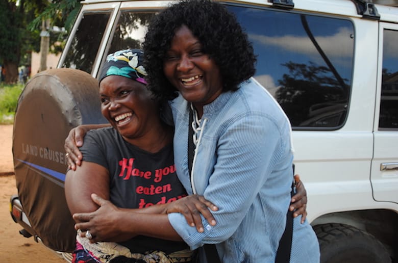 Joyce Mtauka (L) greets Zaida Bastos, PWRDF director of project relationships, in Ruponda village. Photo: André Forget