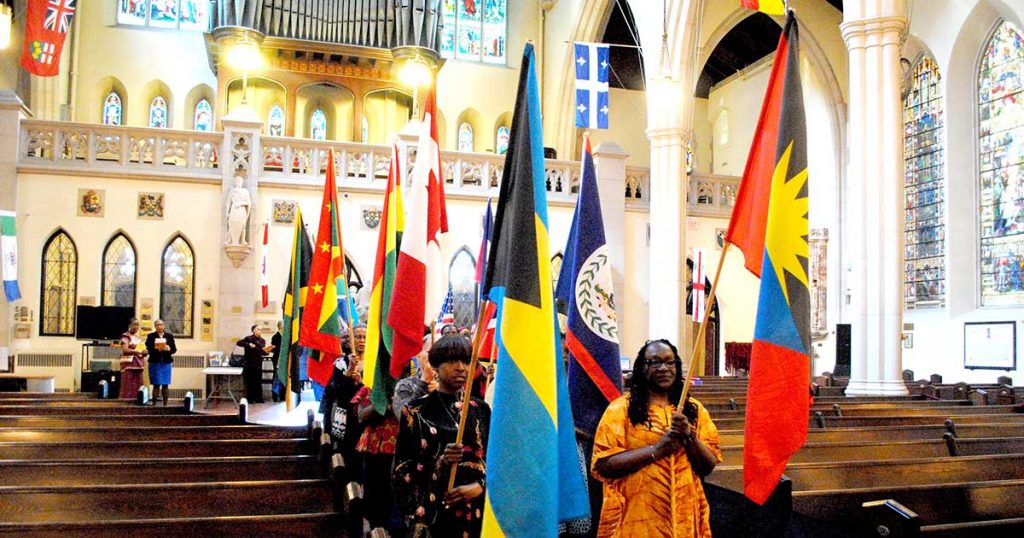 Participants in the 25th annual Black history service at St. Paul’s Bloor Street form a procession before the service begins, carrying flags of their countries of origin. Photo: Tali Folkins