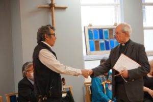 Welby shakes the hand of former Mohawk Institute student Geronimo Henry during his May 3 meeting with Indigenous leaders and residential school survivors in Toronto. Photo: Anglican Video